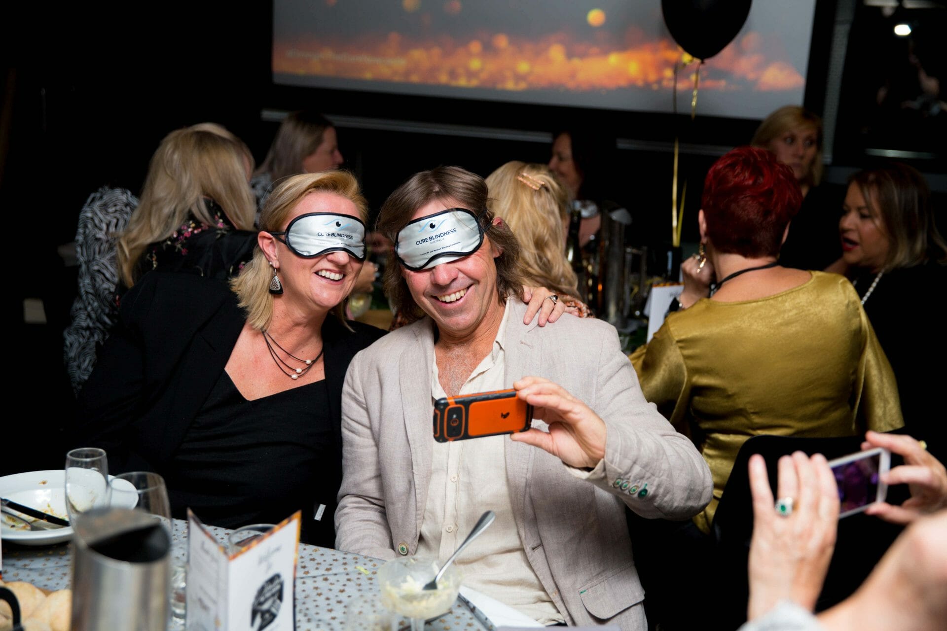Couple taking selfie for Cure Blindness Australia charity event